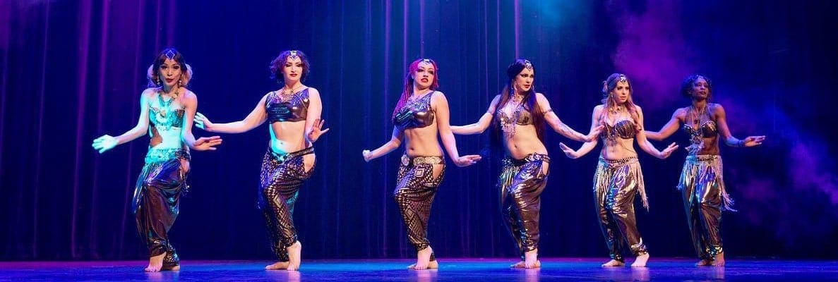 Six belly dancers performing on stage